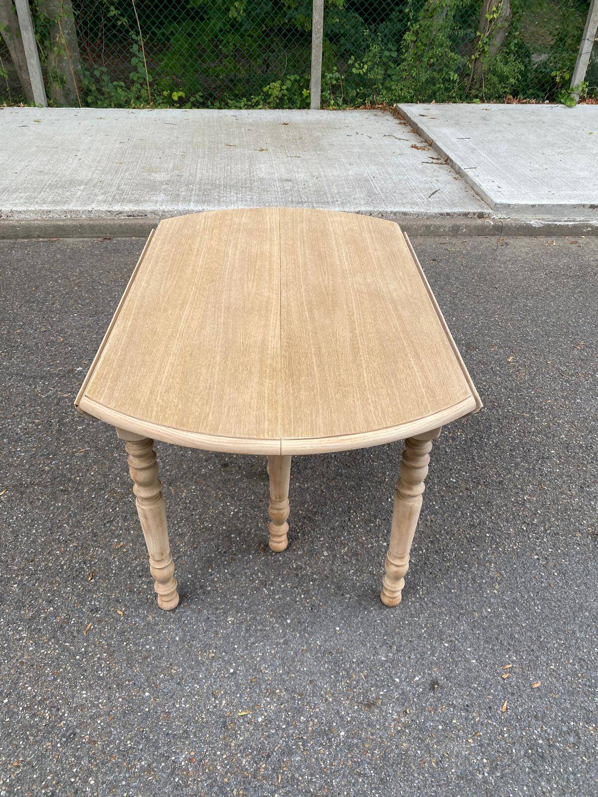 Round dining table with extendable leaves, Louis Philippe style, stripped in raw oak.
