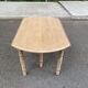 Round dining table with extendable leaves, Louis Philippe style, stripped in raw oak.