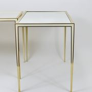 A pair of brass and white mirror tables from Vereinigte Werkstätten, Germany, 1970s.