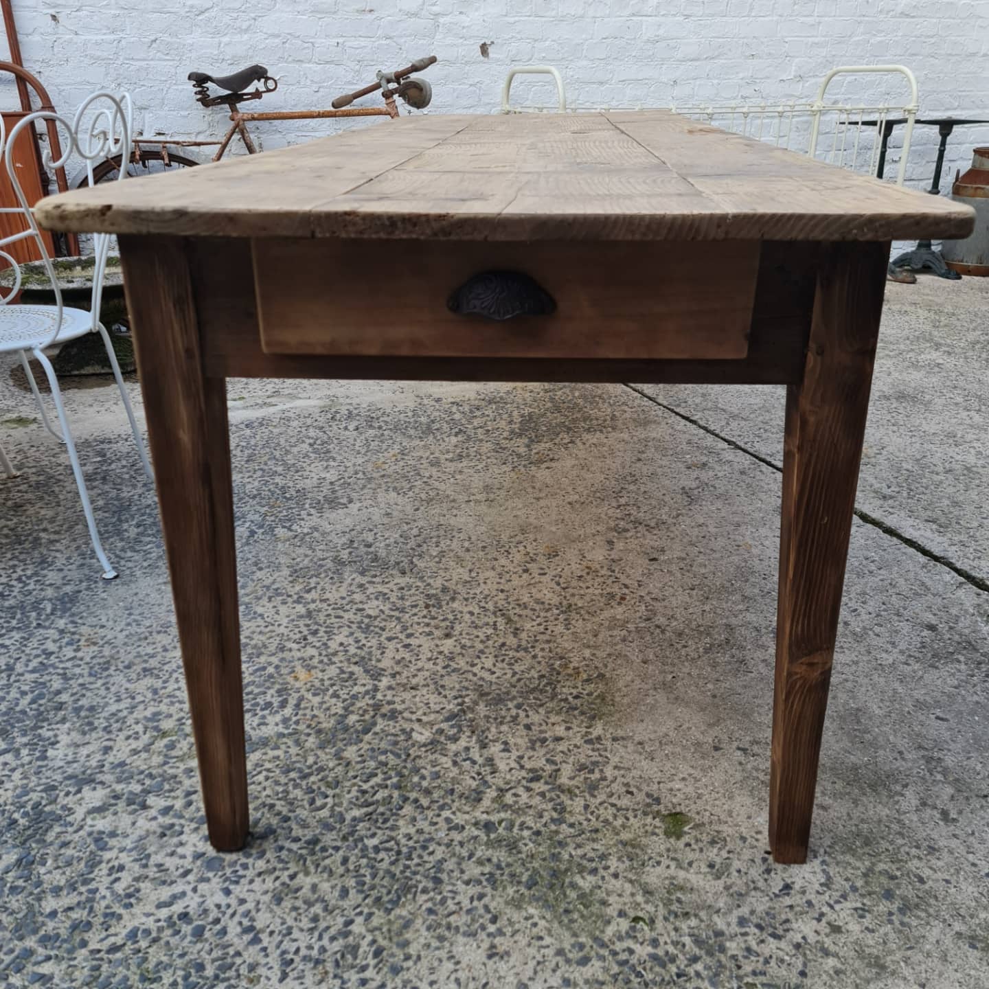 Large antique farmhouse table with a drawer