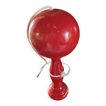 Large red wooden cup-and-ball game, 9 cm in diameter.