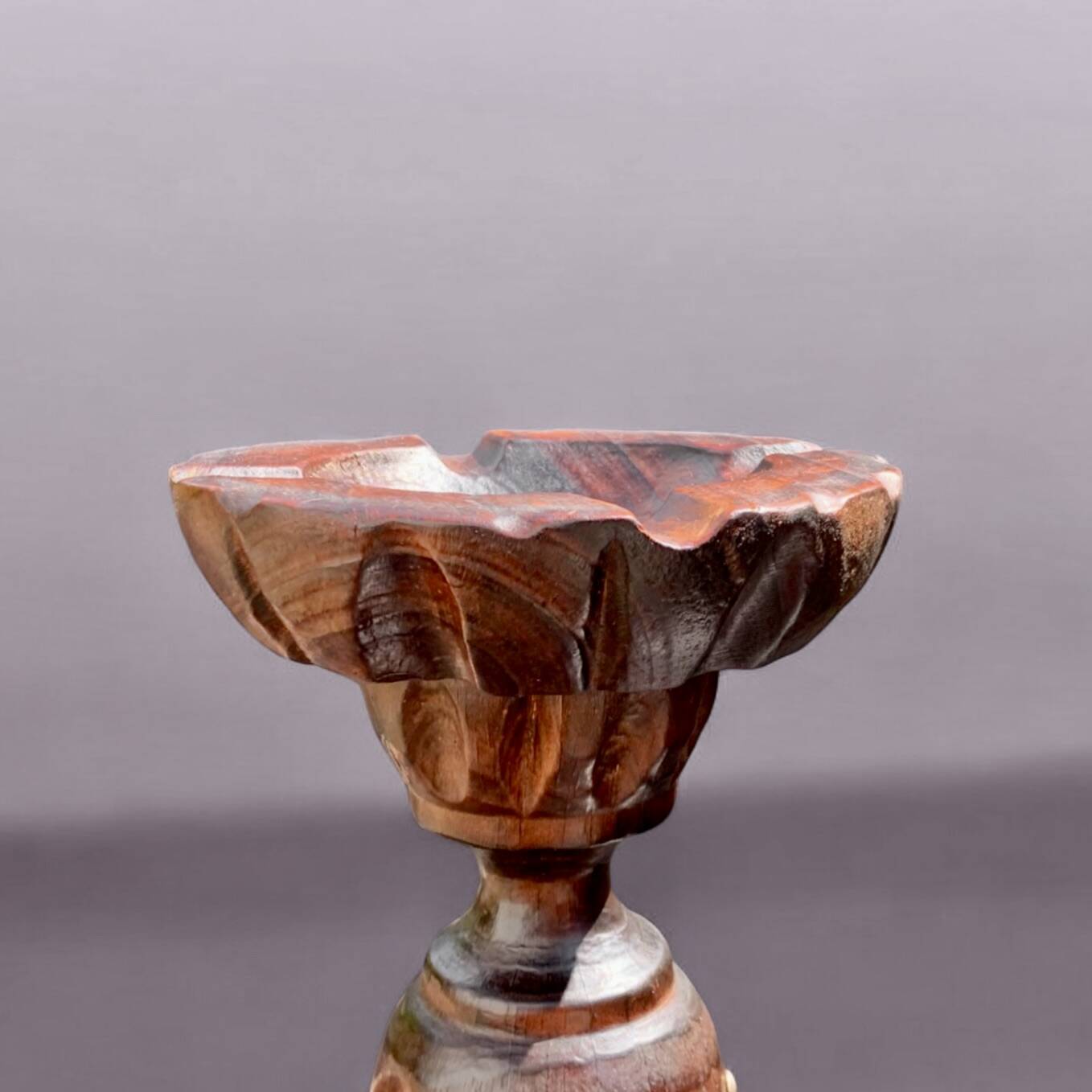 Old ashtray on carved wooden stand