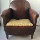 Club armchair in studded leather - early twentieth century