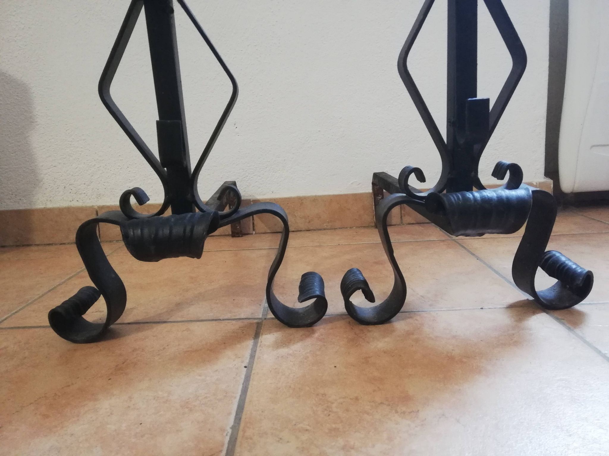 Pair of wrought iron andirons and brass ball.