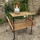 Vintage 1950s rolling dessert trolley in wicker and black tubing.