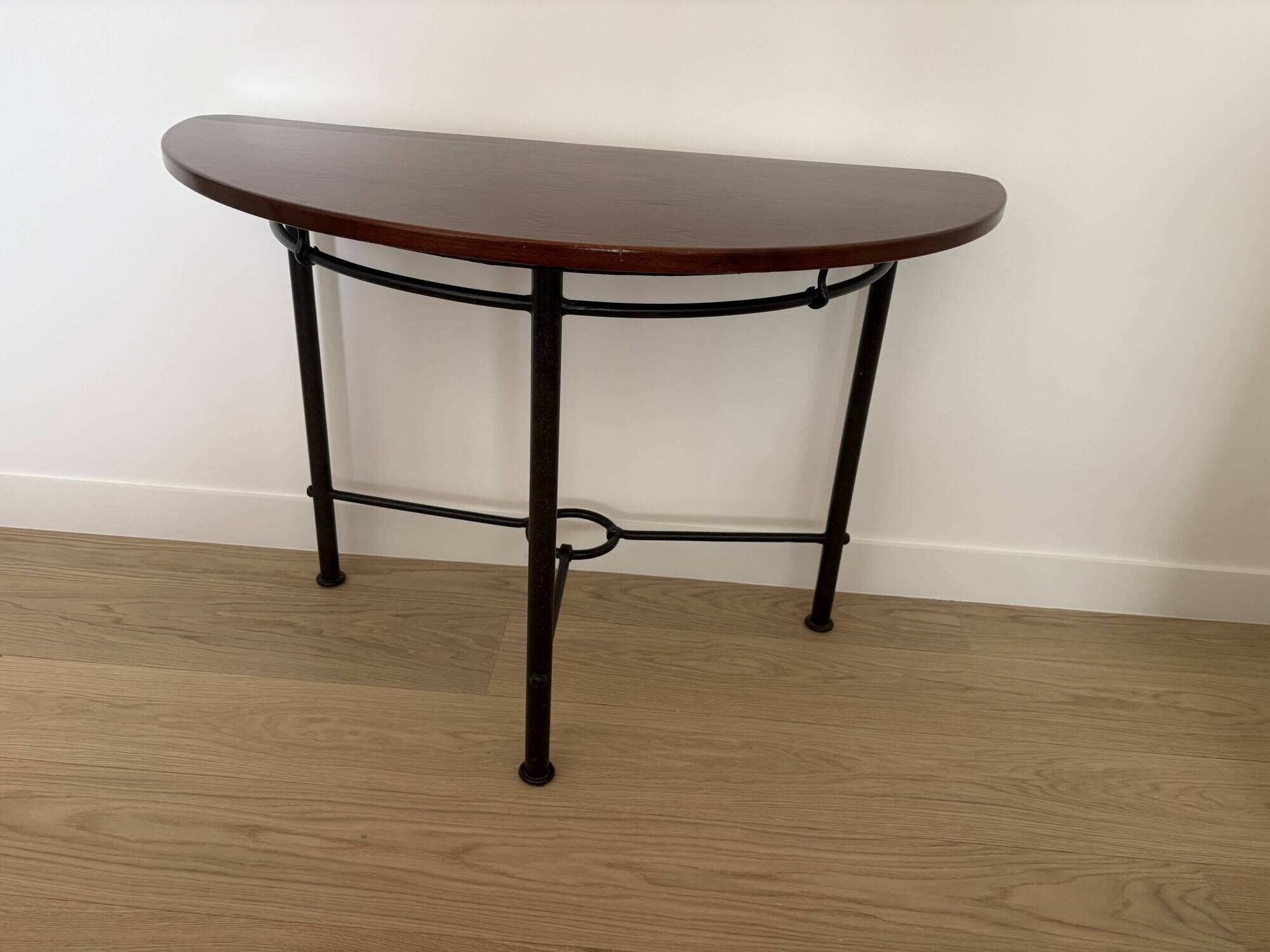 Half-moon console grange in solid cherry wood and wrought iron with a glass top.