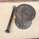 Ancient large mortar and pestle of a black cast iron apothecary.