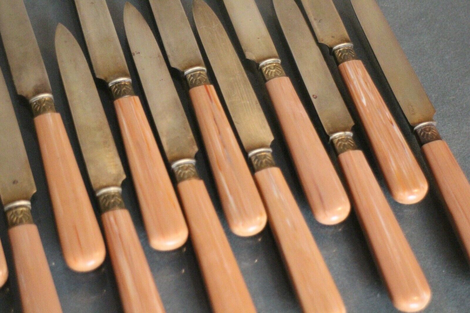 Suite of 12 dessert knives in gold metal blades