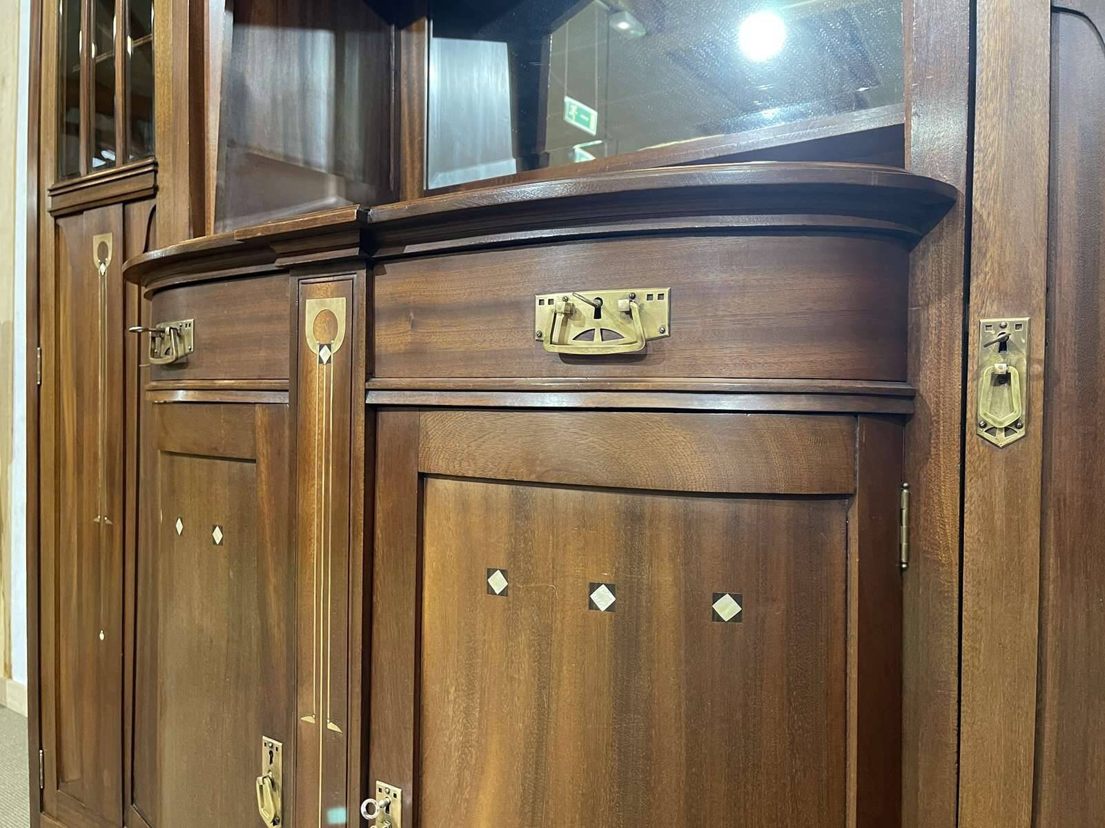 Art Nouveau mahogany buffet with clock in the style of G. Serrurier Bovy.