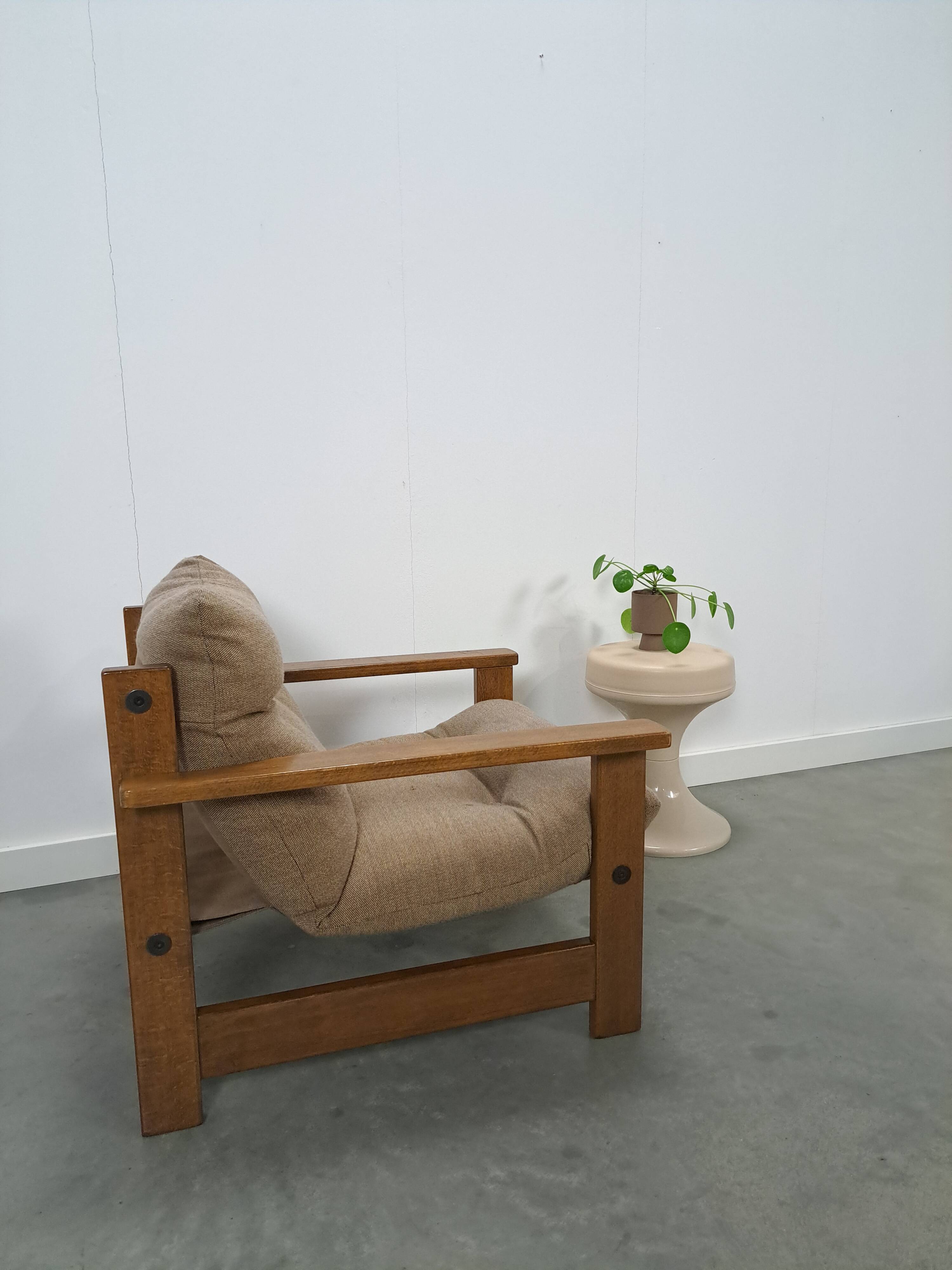 Brown-grey armchair with an oak frame.