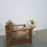 Brown-grey armchair with an oak frame.