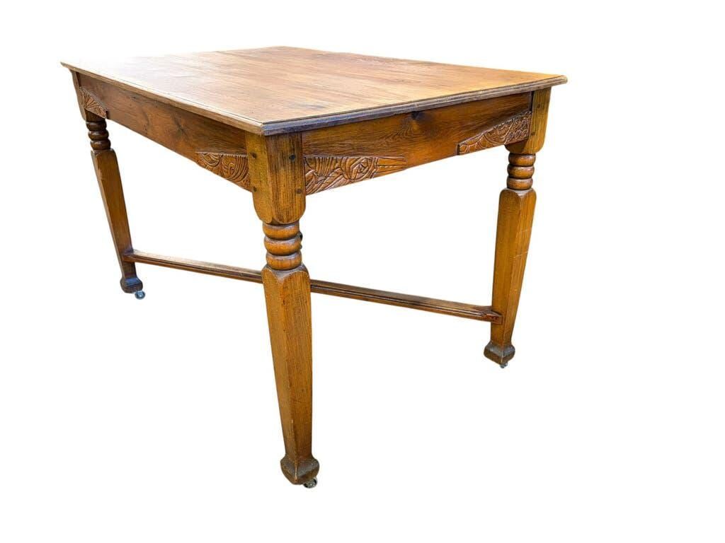 Vintage solid wood table with X-cross on wheels.