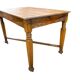 Vintage solid wood table with X-cross on wheels.
