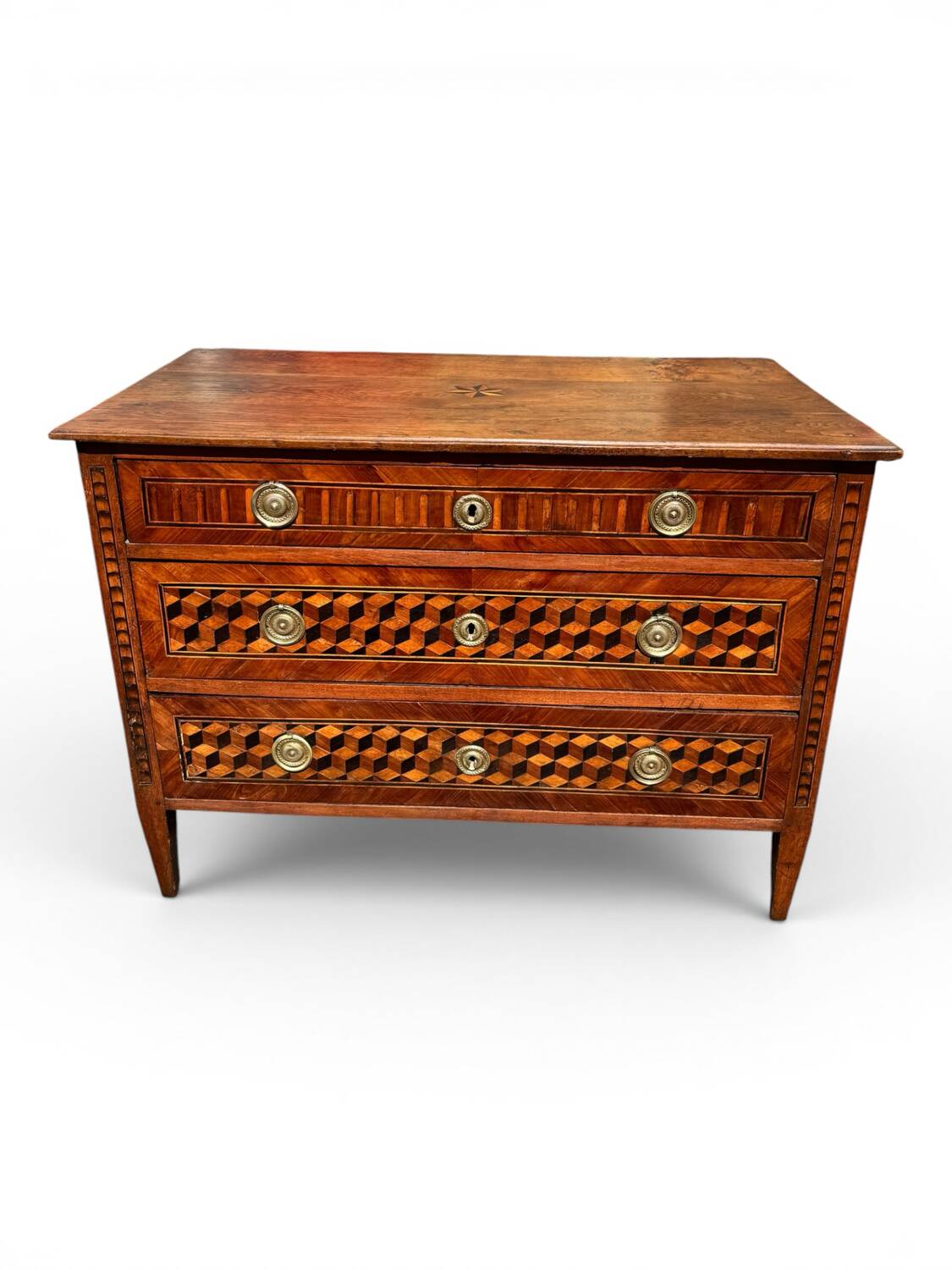 Louis XVI commode with marquetry featuring a design of precious wood cubes, 18th century.