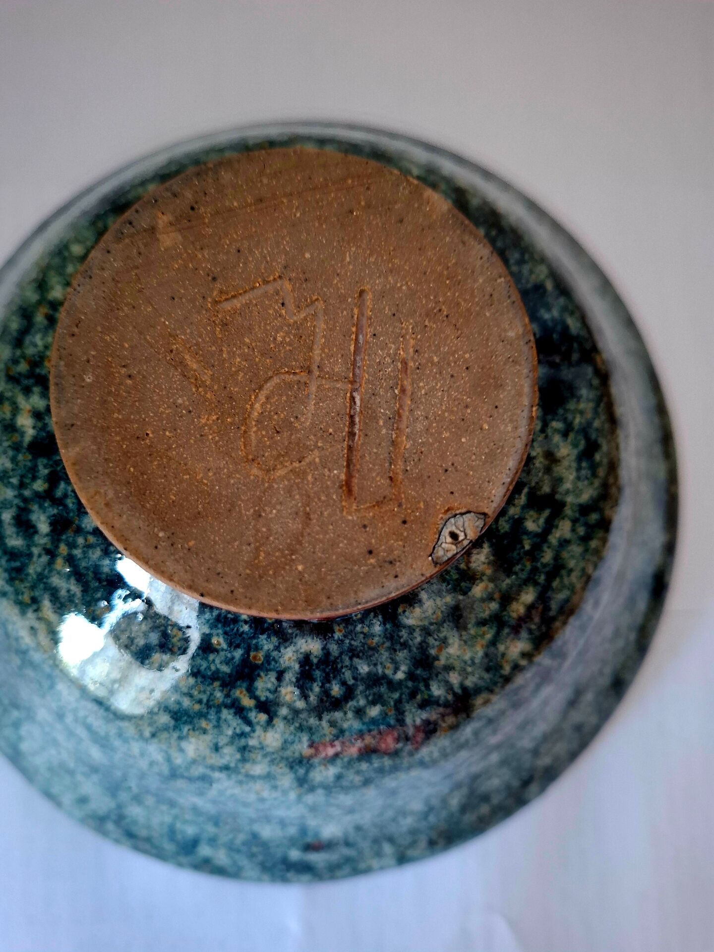 Bowl on a circular base or small blue ceramic dish.