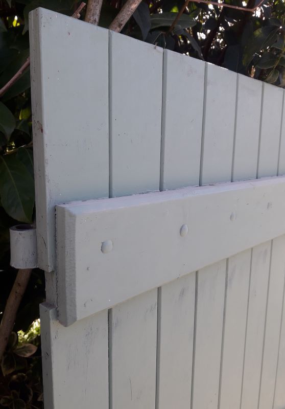 Pair of wooden shutters hanging iron