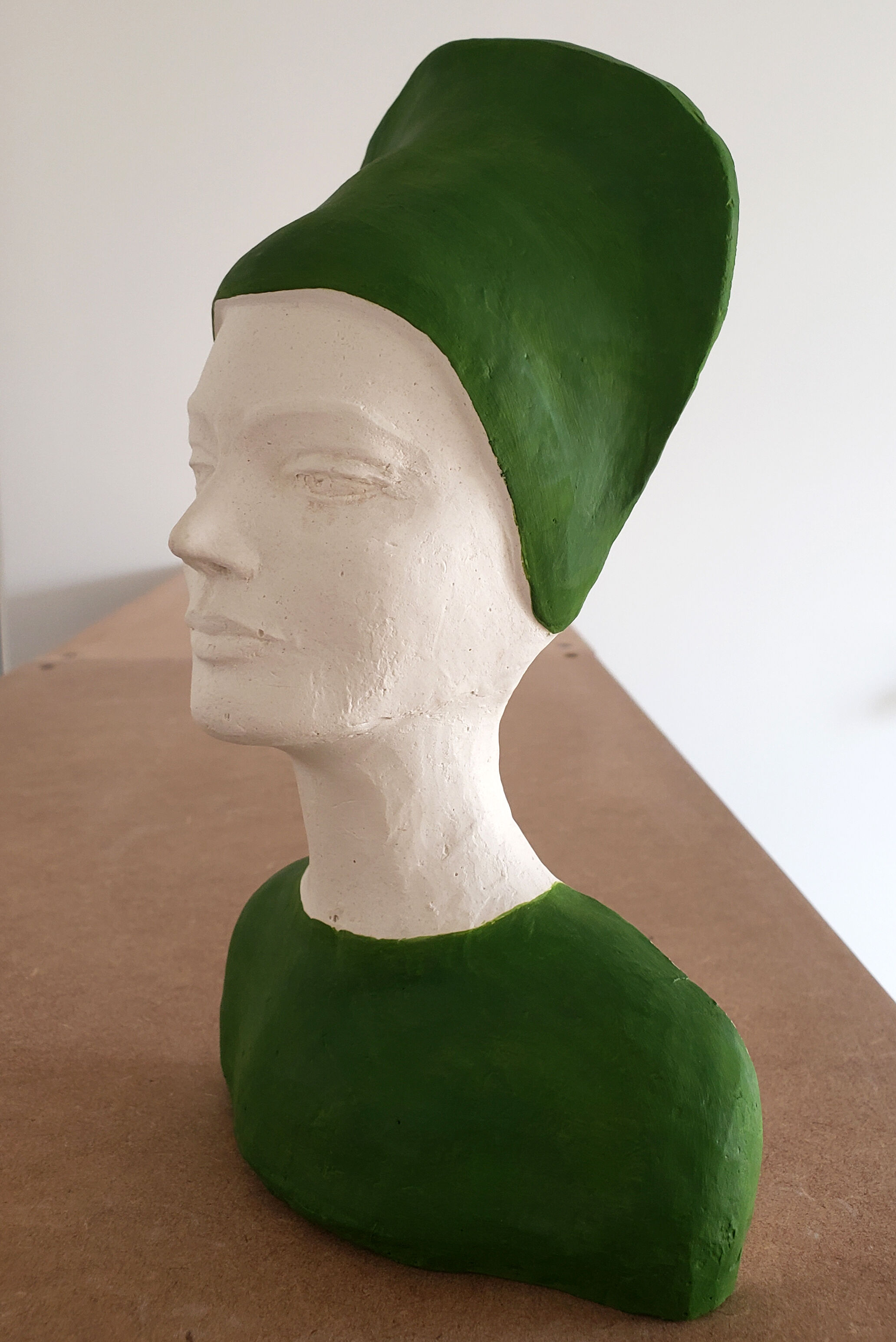 Bust of a woman in green and white plaster