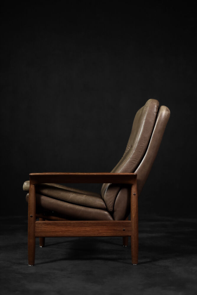 High teak and brown leather armchair with reclining backrest, mid-century Danish style, 1960s.