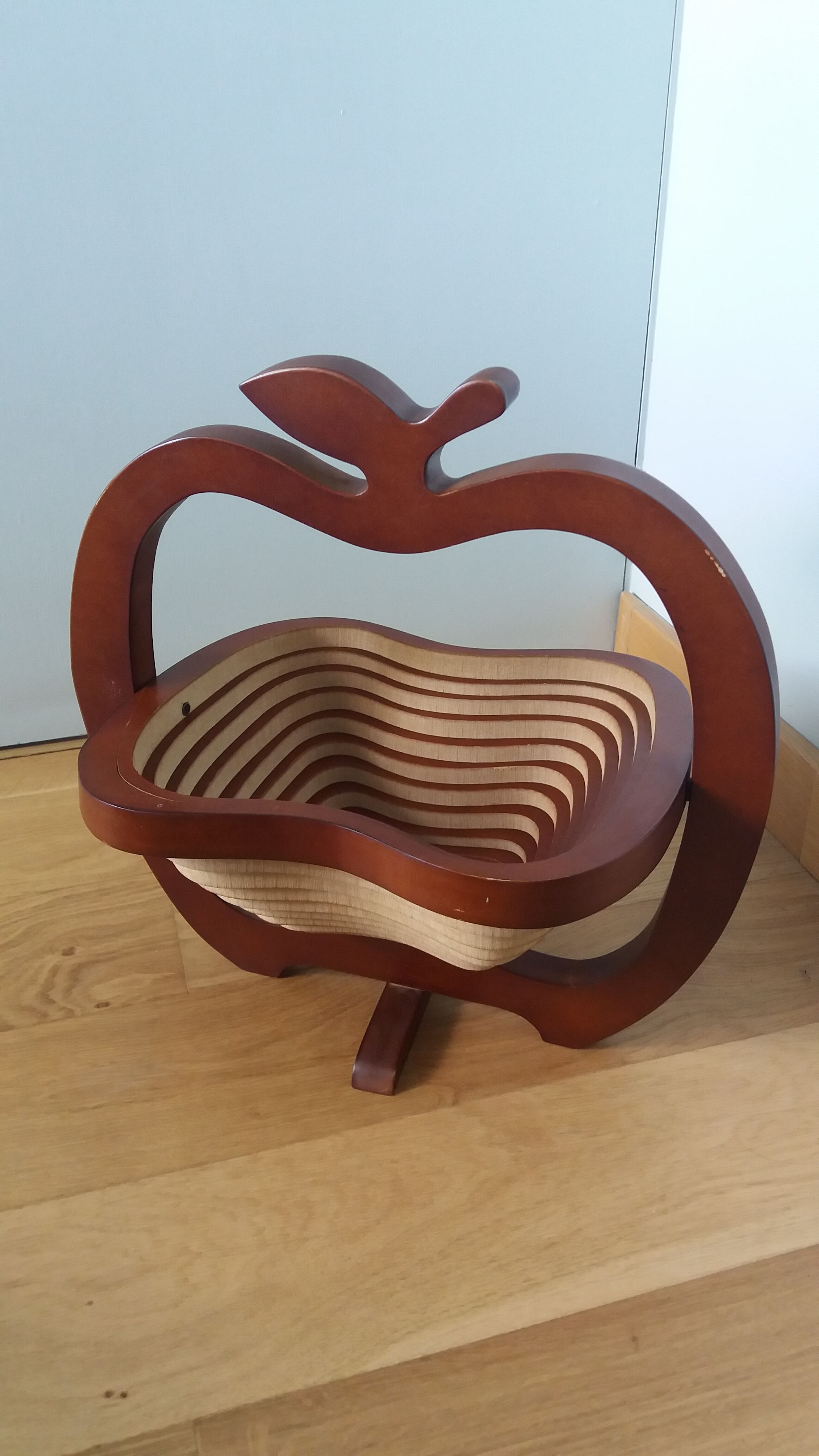 Foldable fruit basket in the shape of an apple.