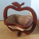 Foldable fruit basket in the shape of an apple.