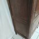 Bonnetière man standing cabinet a door