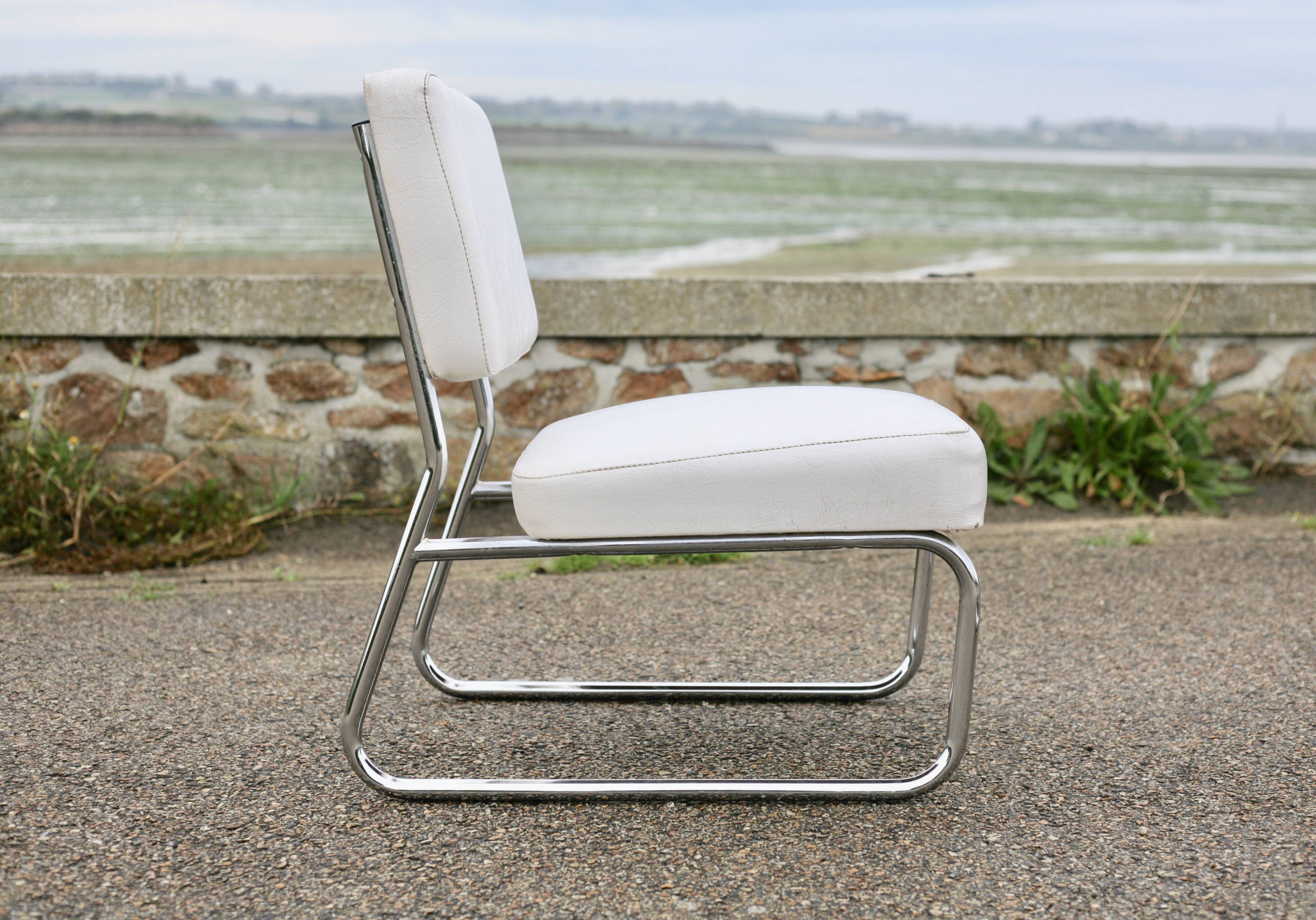 4 armchairs forming a modular sofa. Steel, imitation leather, 70s