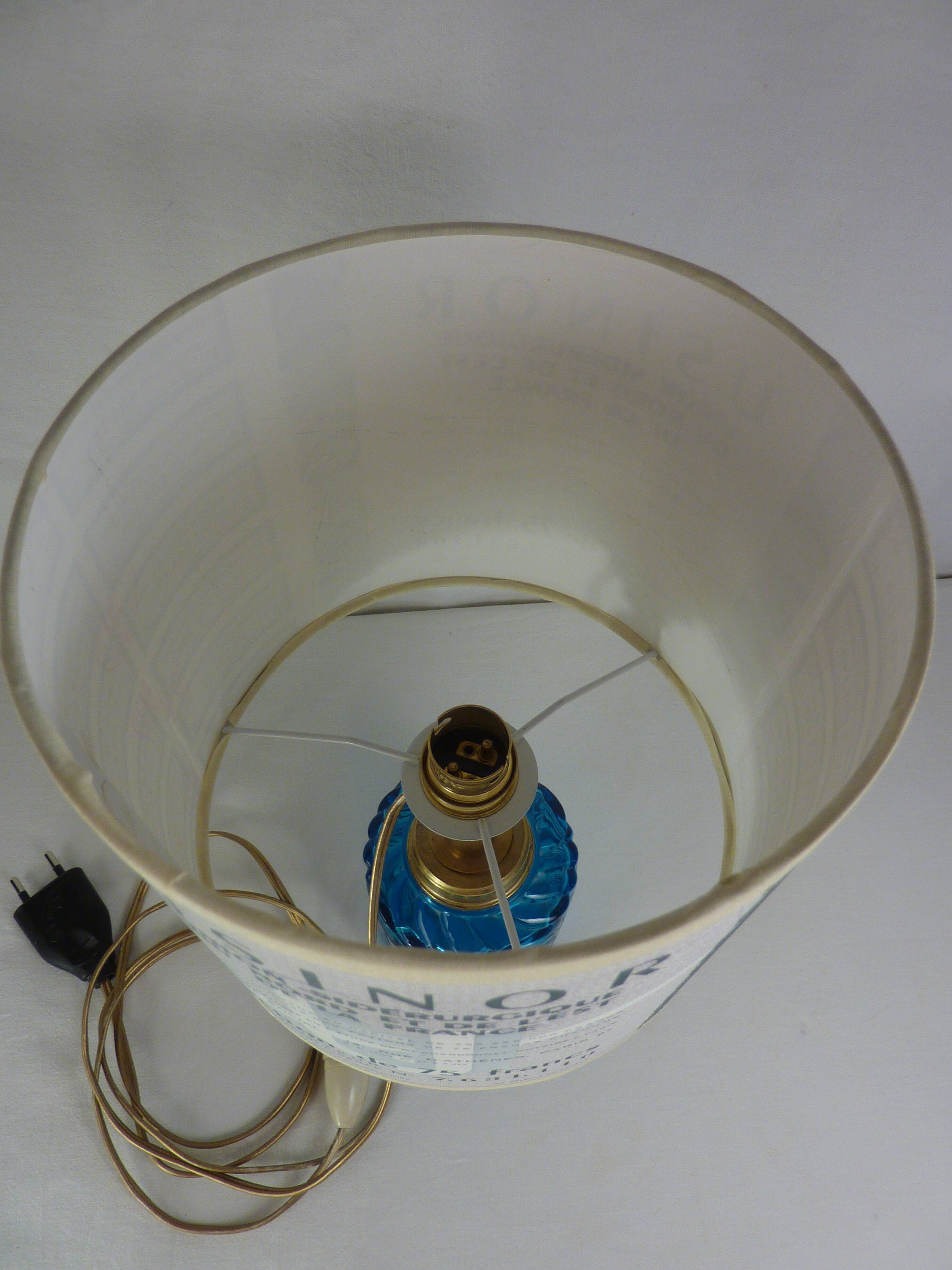 Table lamp with king blue and gold glass foot and machineinor action lampshade