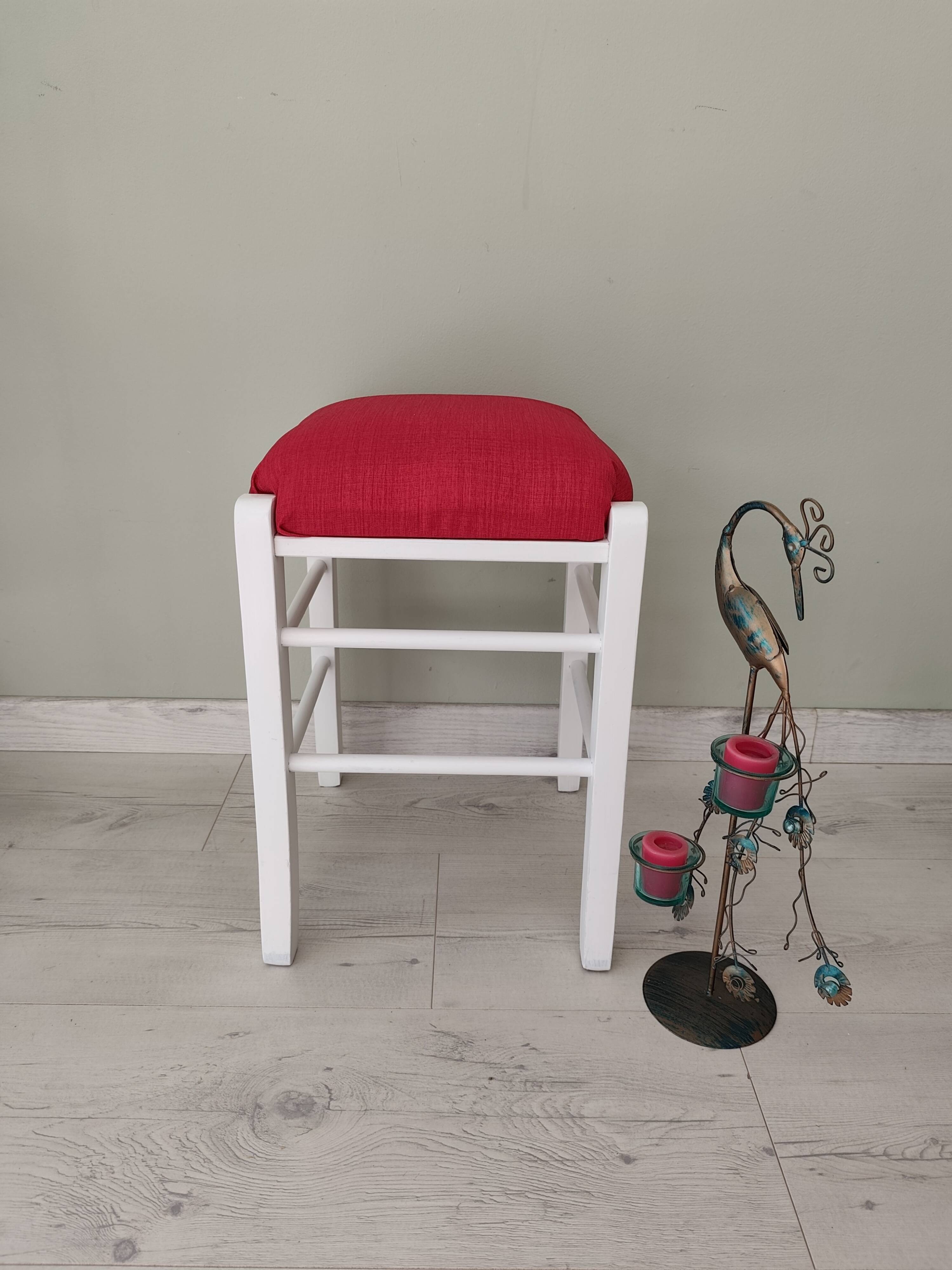White pine stool with a red seat.