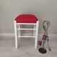 White pine stool with a red seat.