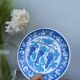 Blue decorative plate with grapes