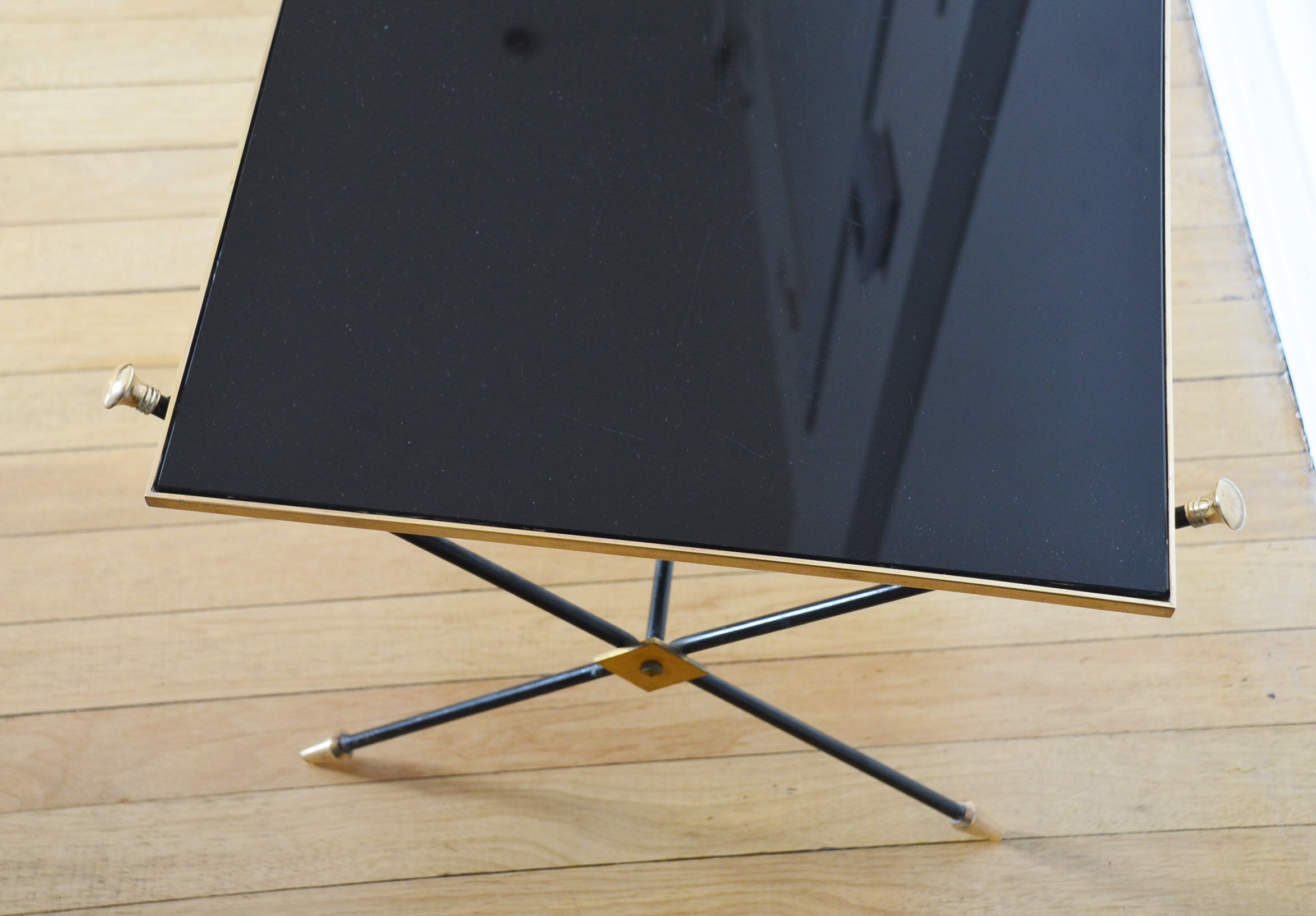 Black glass and brass coffee table in the 1960s
