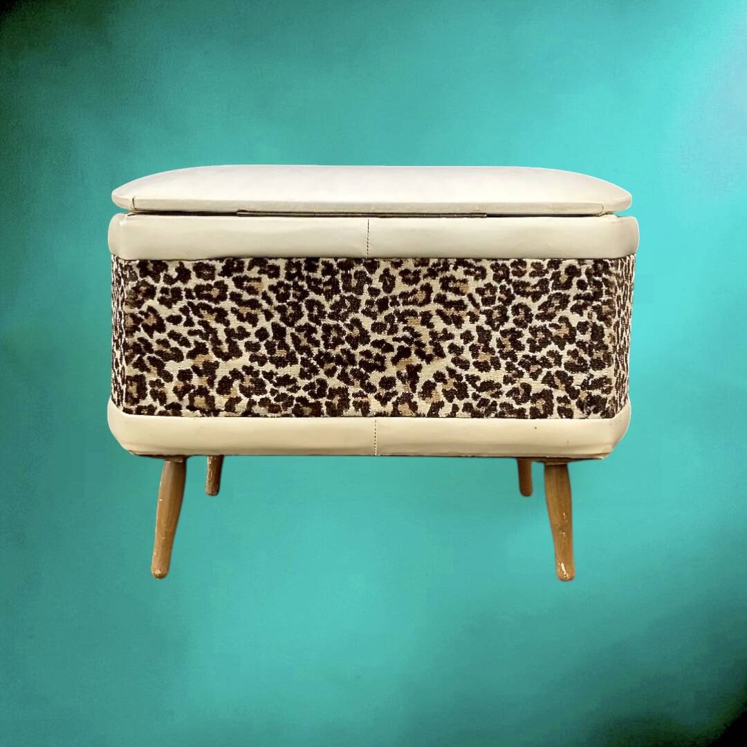 Vintage storage stool with compass legs in white faux leather and leopard velvet.