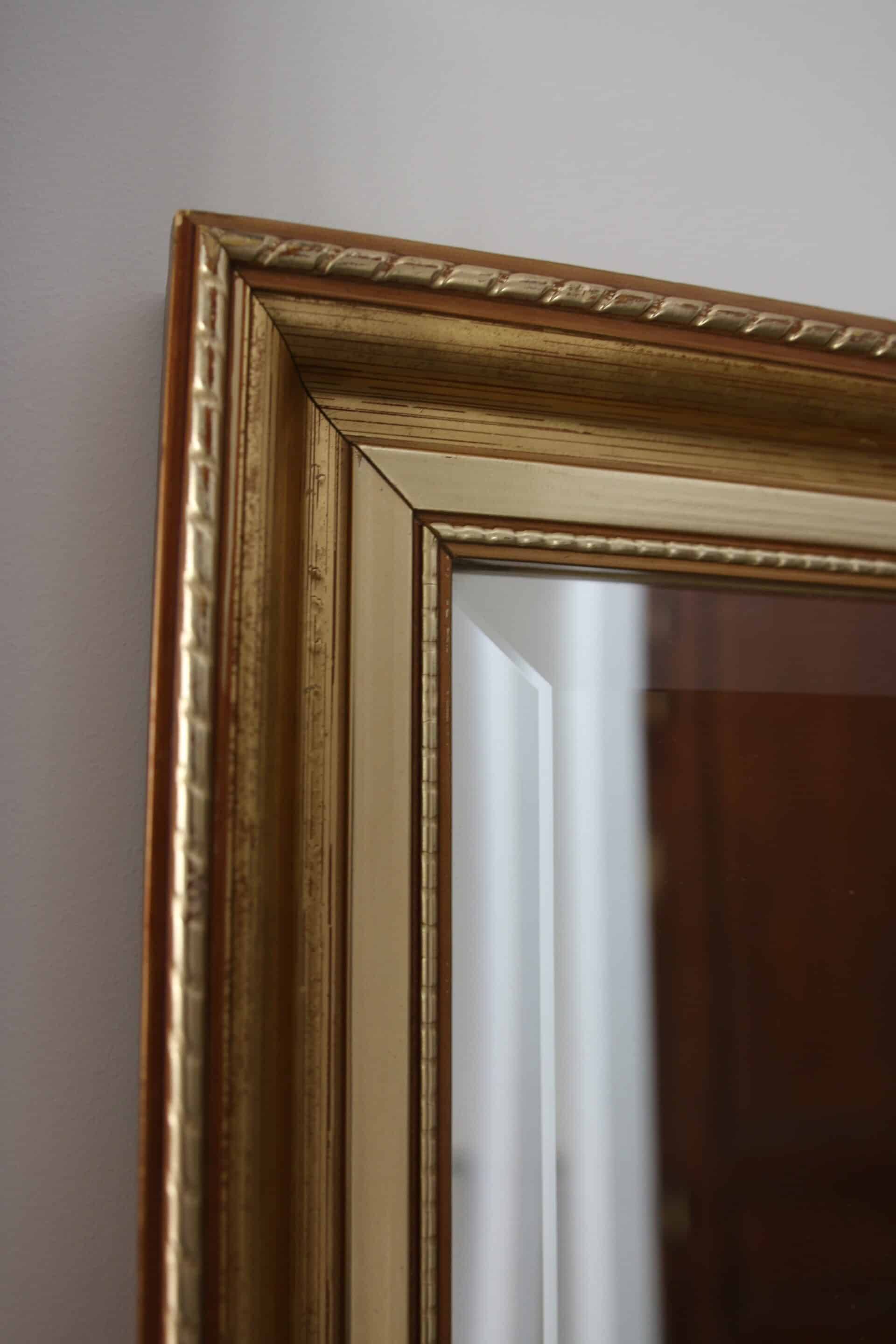 Large beveled mirror in carved wood