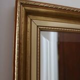 Large beveled mirror in carved wood