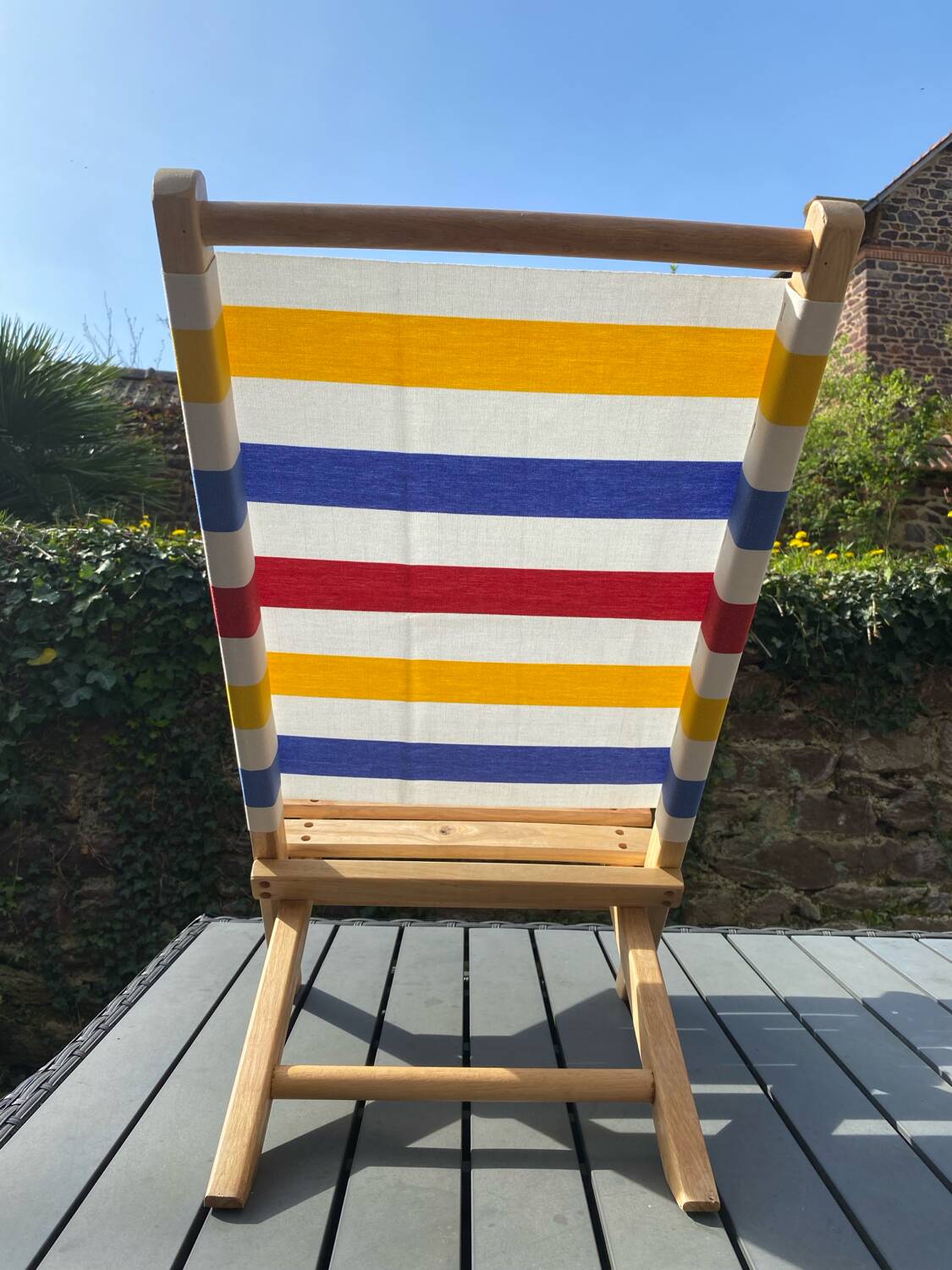 Folding chair in wood and striped fabric