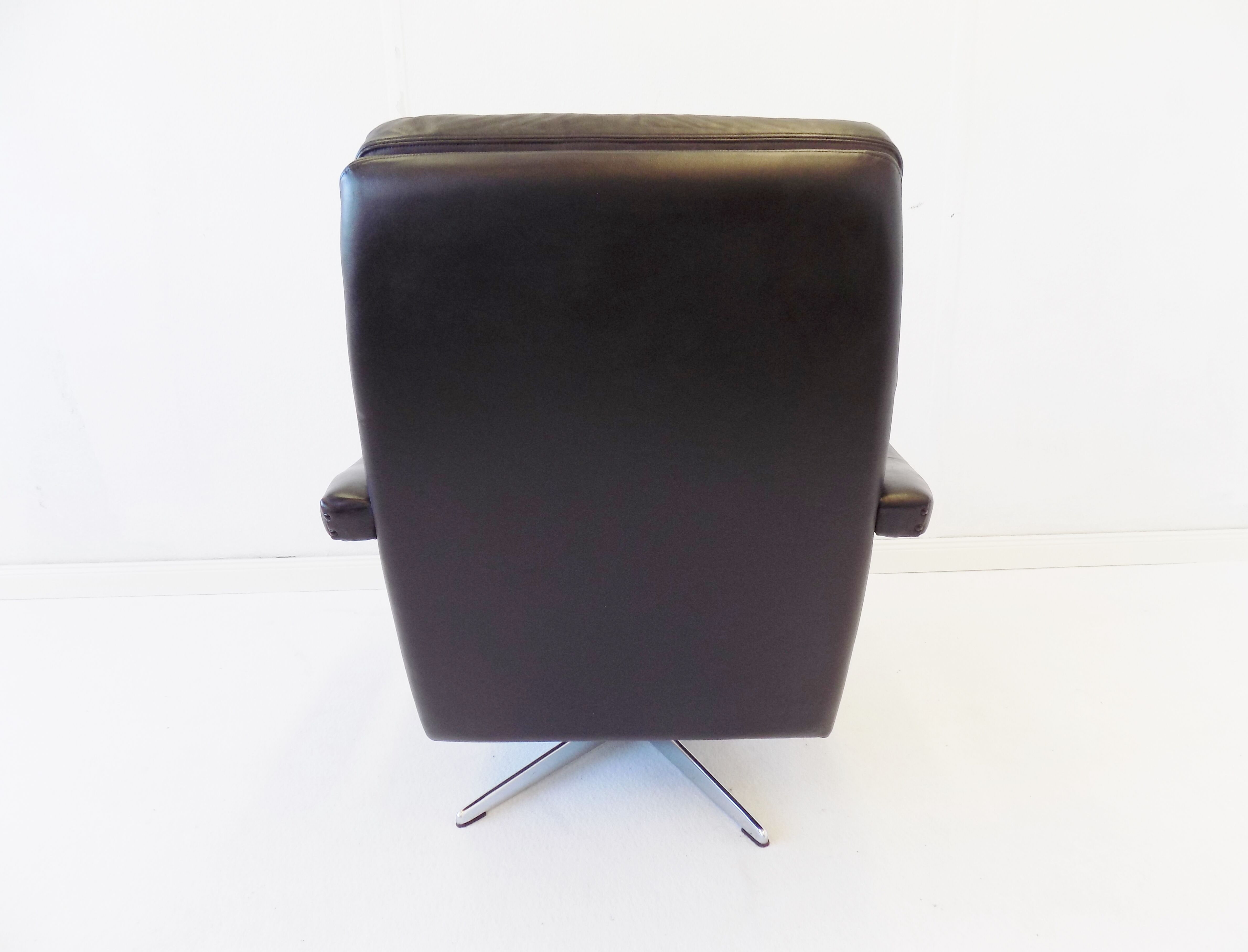 Danish black leather armchair with ottoman 70s