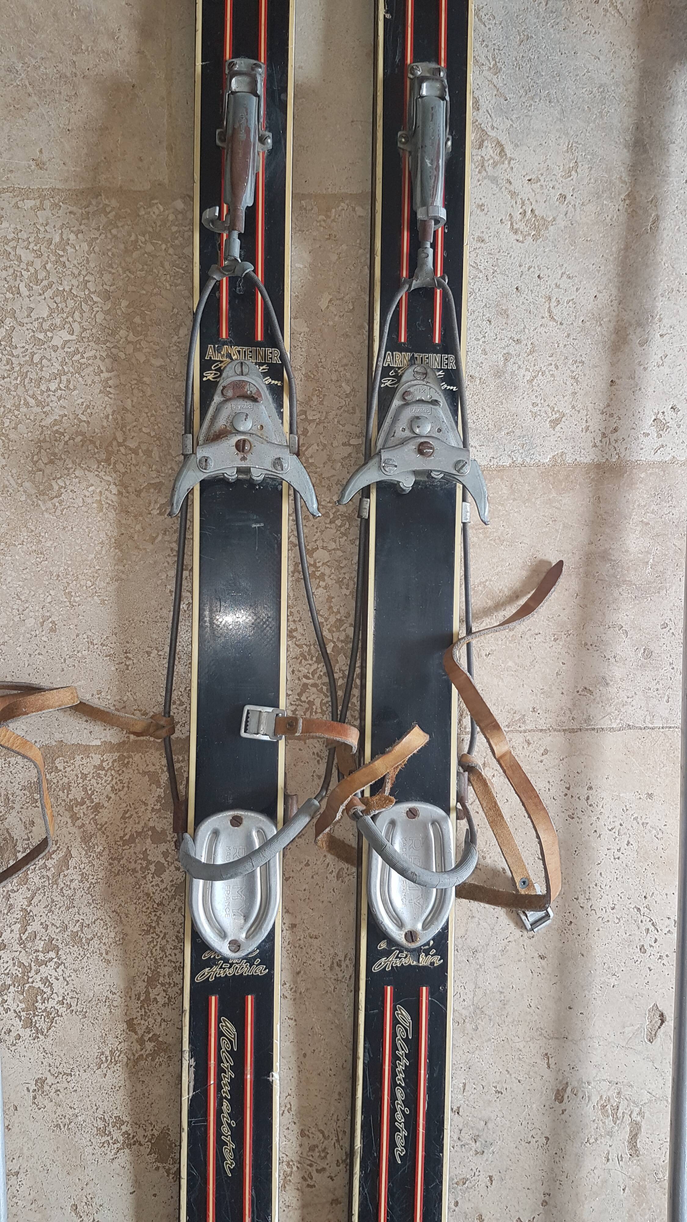 Old skis wooden and its pair of sticks