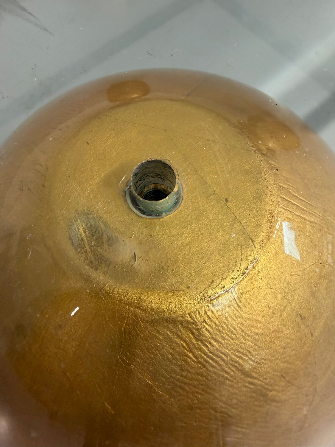 Vintage Italian design coffee table with a glass top and gold base, dating from the 1980s.