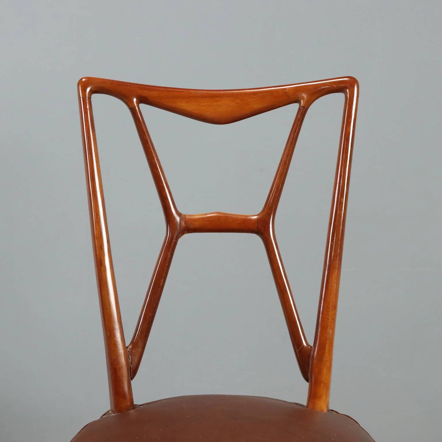 1950s chairs with wooden backs.