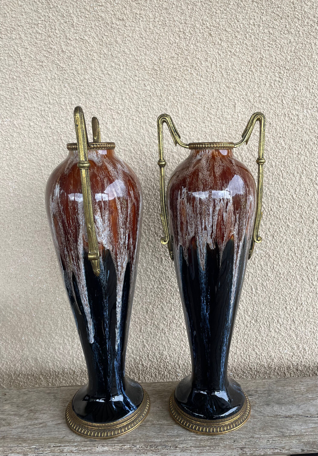 Two large stoneware vases with bronze fittings.