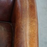 Sheepskin club armchair, correct finishing with decorative nails