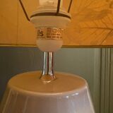 Large beige ceramic table lamp with a vintage shade.