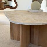 Oval coffee table in travertine and raw oak.