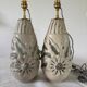 Pair of white glazed stoneware lamp bases, 20th-century floral decoration.