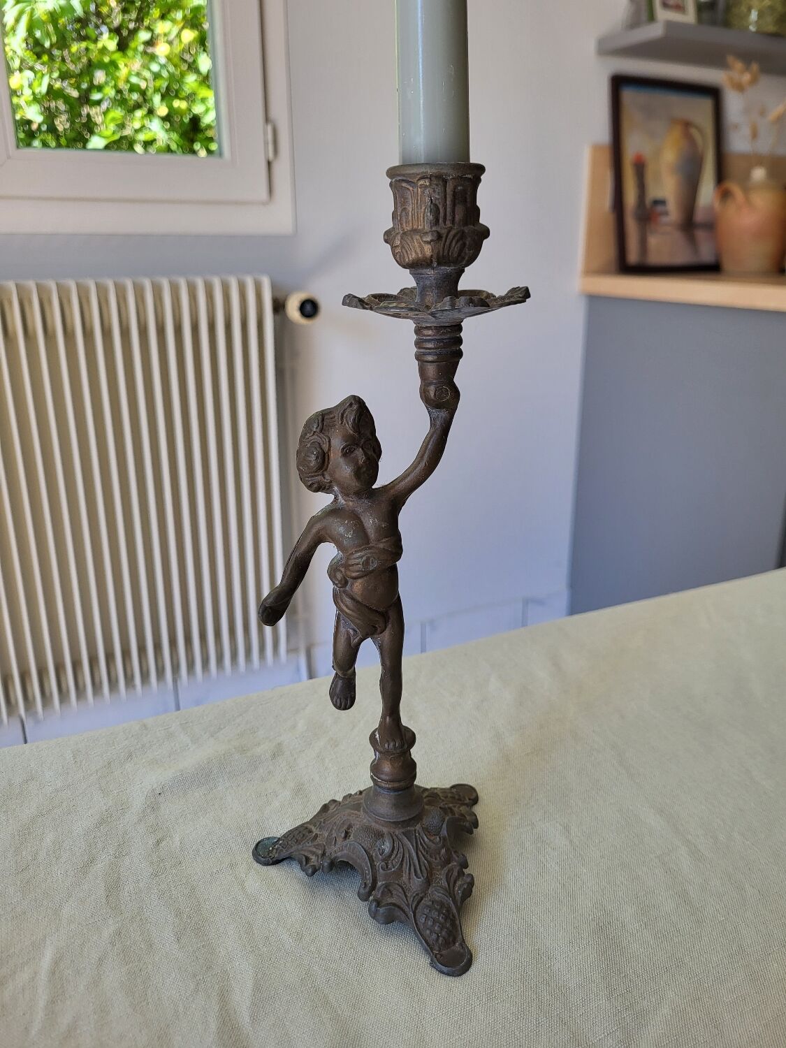 Pewter gray cherub candle holder.