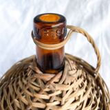 Circled with wicker demijohn