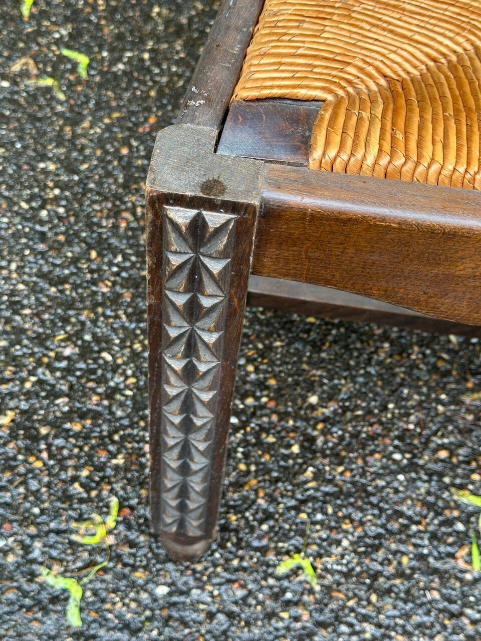 4 Basque solid wood dining chairs with carved straw seats.