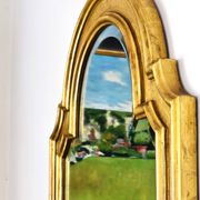 Florentine arched mirror in gilded wood with gold leaf.