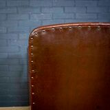 Antique club armchair of leather cloth