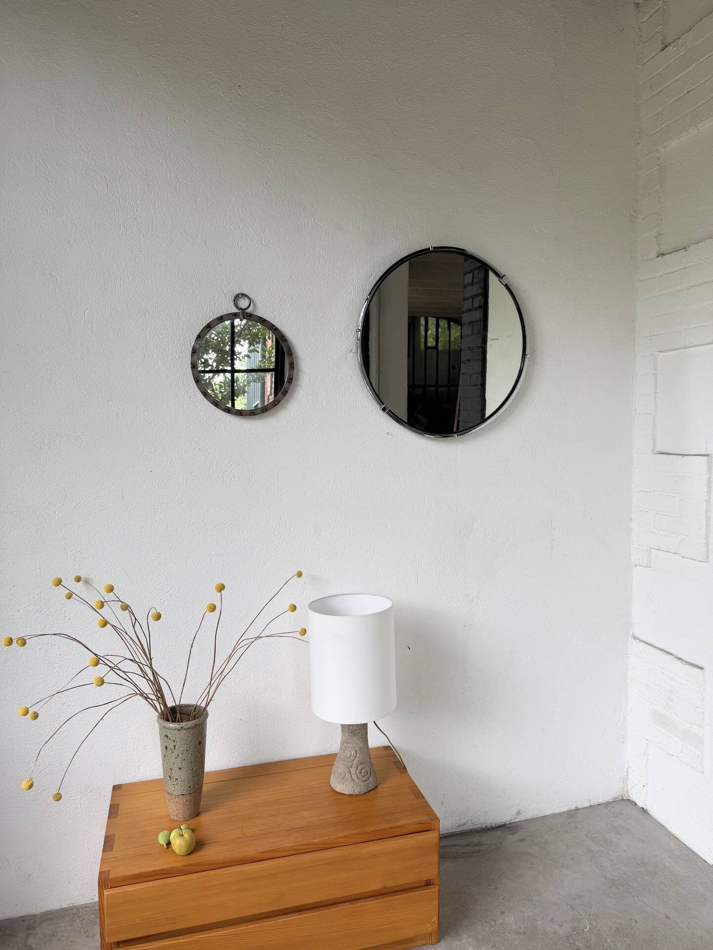 Brutalist round mirror with wrought iron and studs.